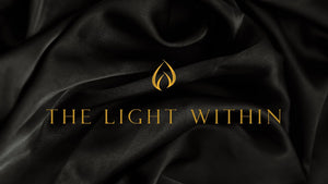 Open image in slideshow, LODGE Soy Candles Gift Card, the design shows black silk fabric with the LODGE Soy Candles logo flame and gold text that reads &quot;the light within&quot;.
