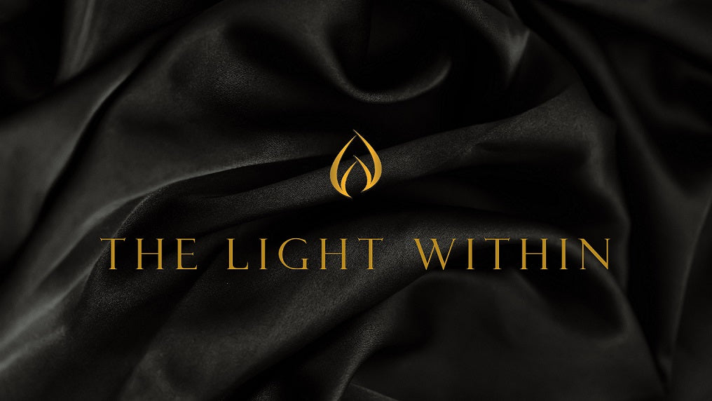 LODGE Soy Candles Gift Card, the design shows black silk fabric with the LODGE Soy Candles logo flame and gold text that reads "the light within".