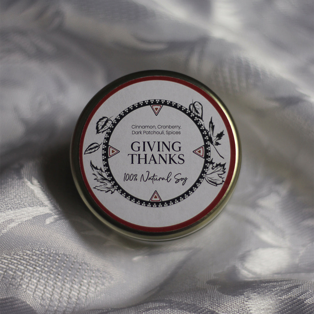 LODGE Soy Candle's Giving Thanks travel tin is made from cinnamon, cranberry, dark patchouli, and spices.